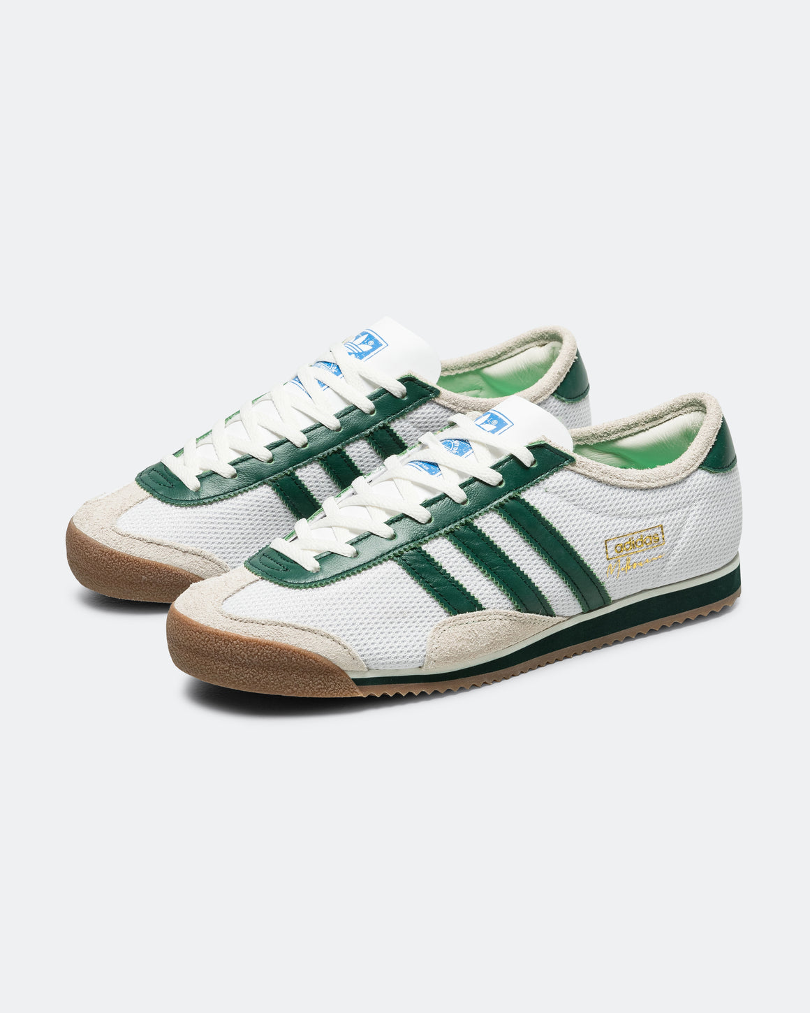 UP THERE x adidas Melbourne White Dark Green hero image showing white mesh upper and dark green Three Stripes